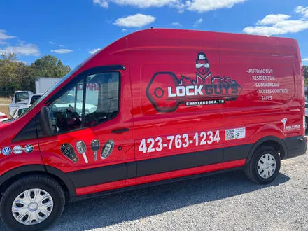 A red Lock Guys of Chattanooga service van with the company logo and phone number