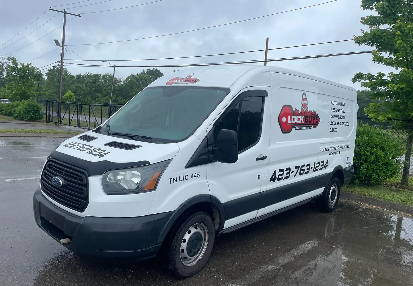 A white Lock Guys of Chattanooga service van marked TN LIC-445 and the phone number